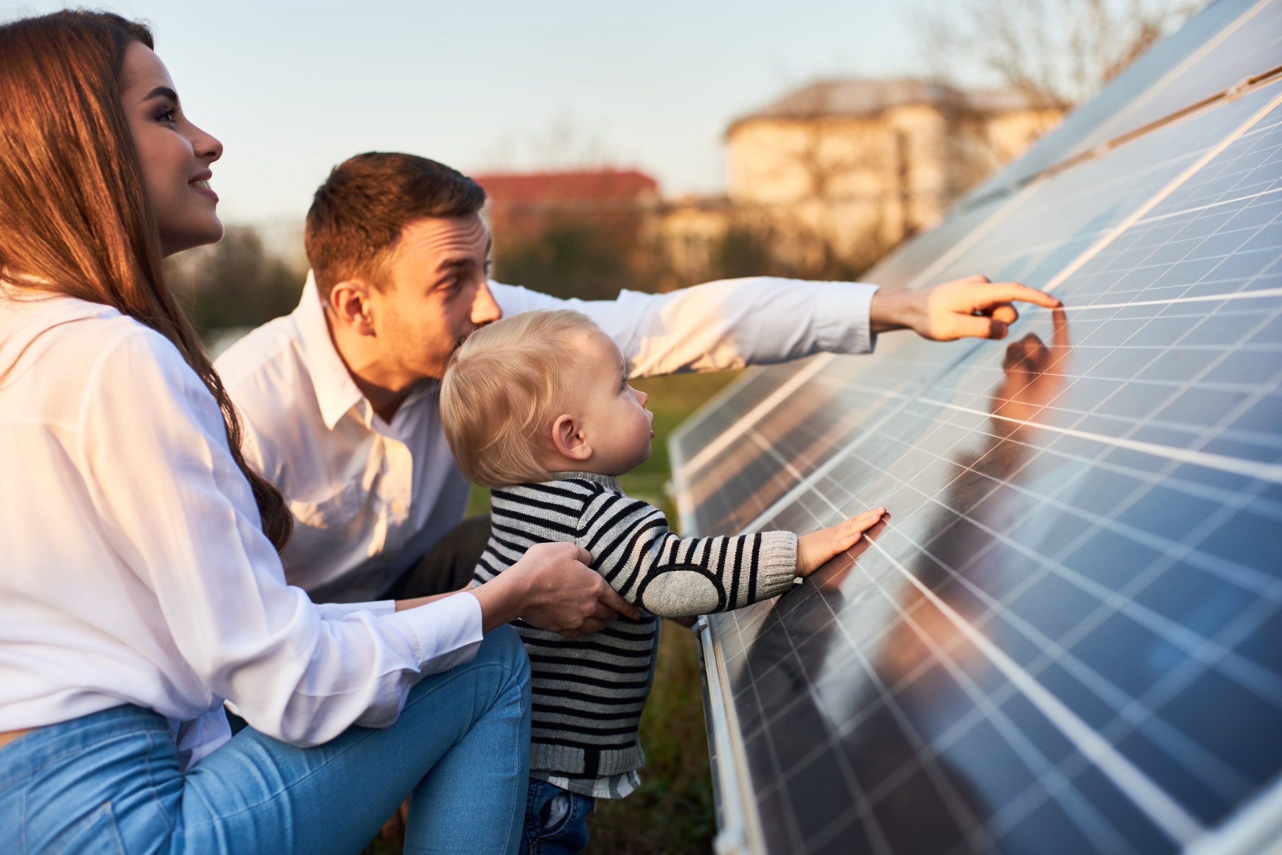 family looking at solar panels