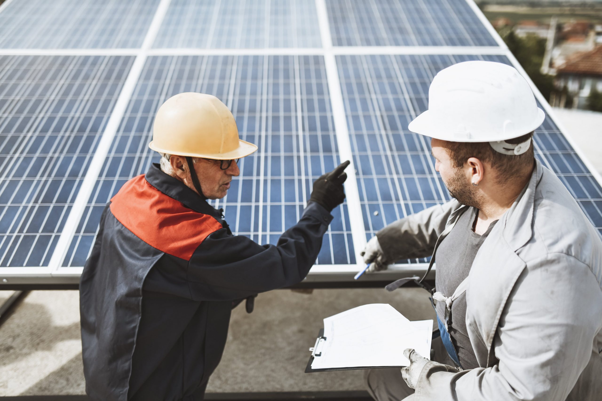 Men inspecting solar panels