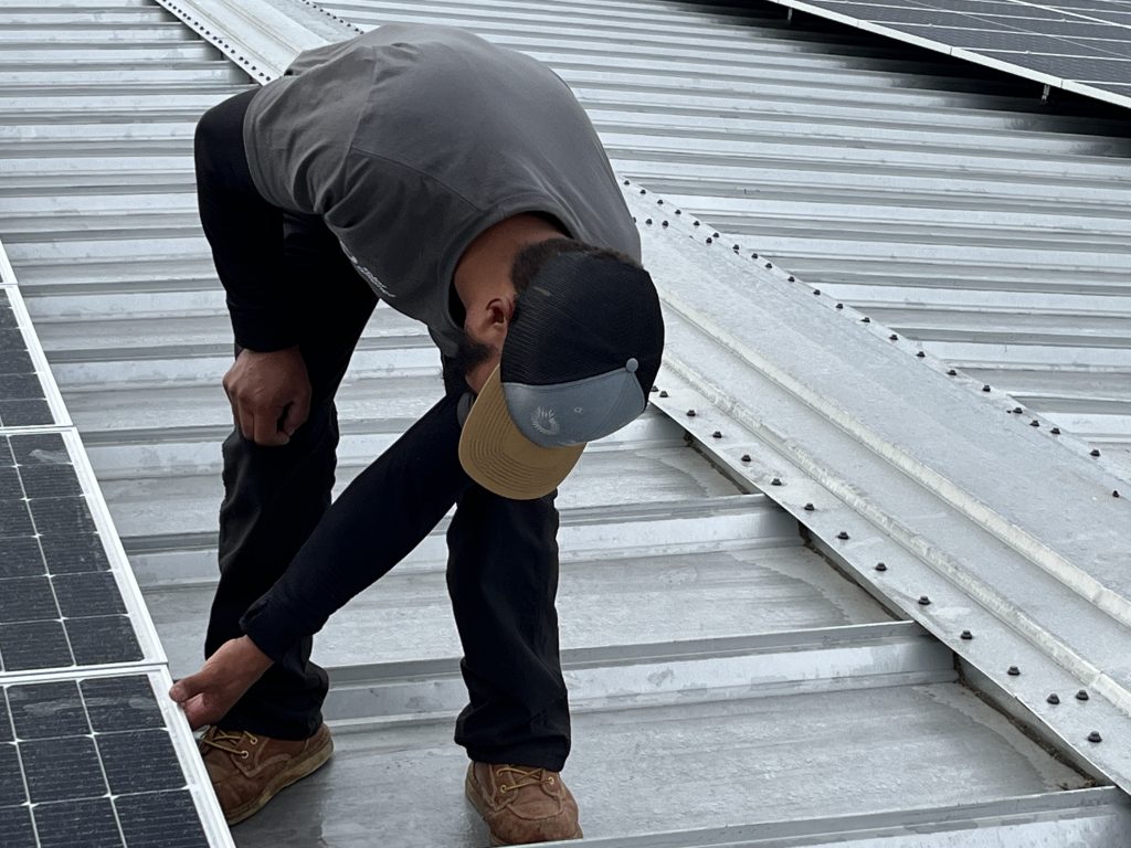 Solar Alliance installer working on metal roof