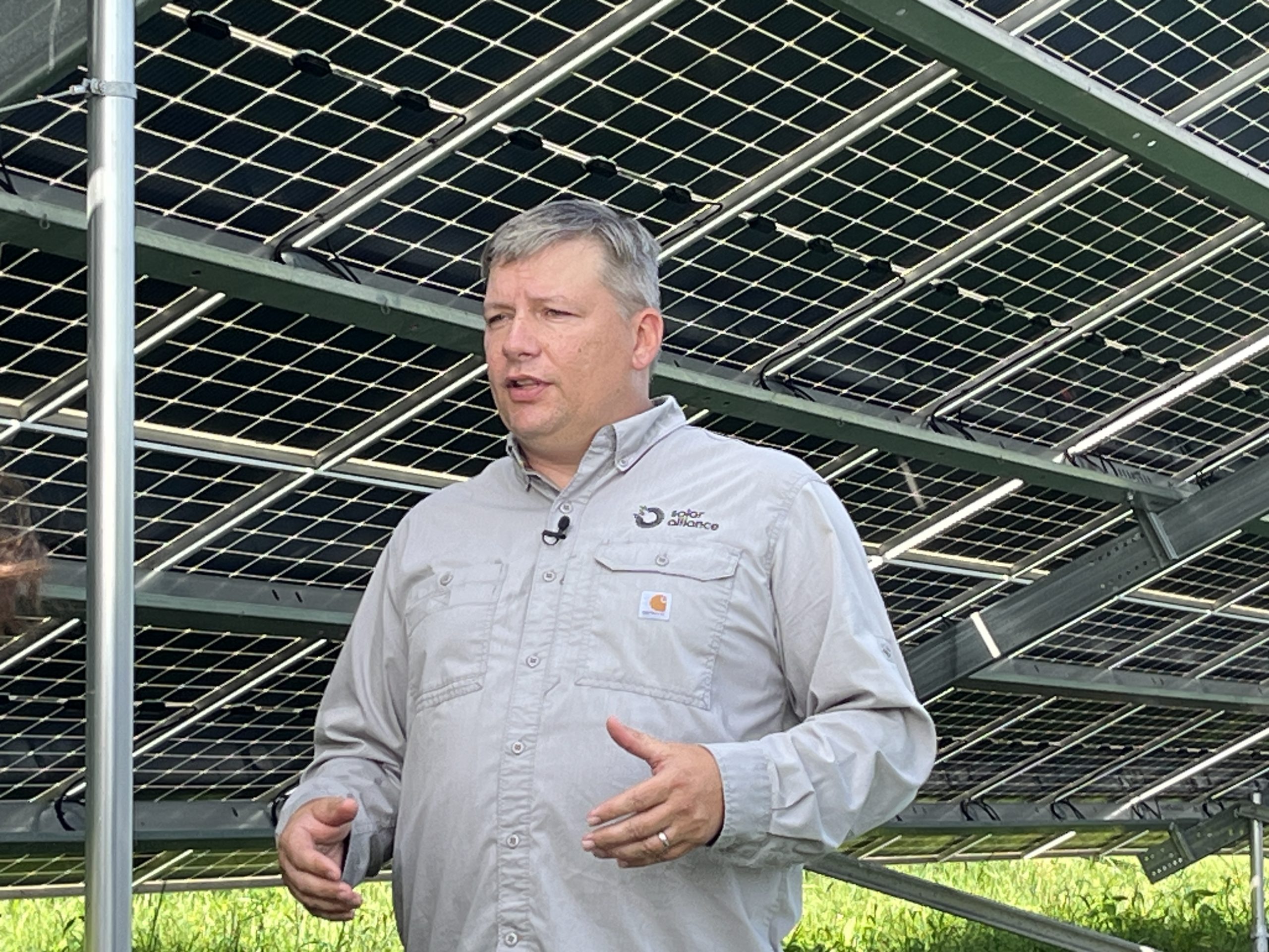 Solar Alliance General Manager teaching amid solar array.