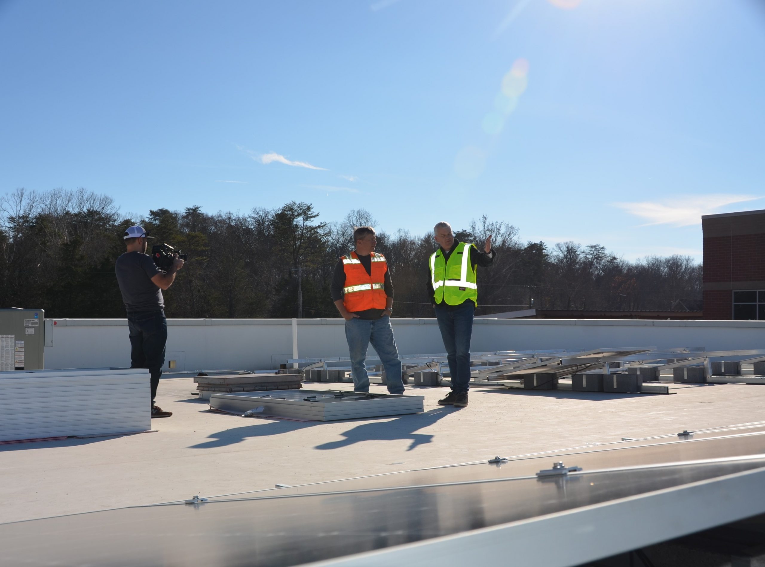 Business owners oversees solar installation on his office building.