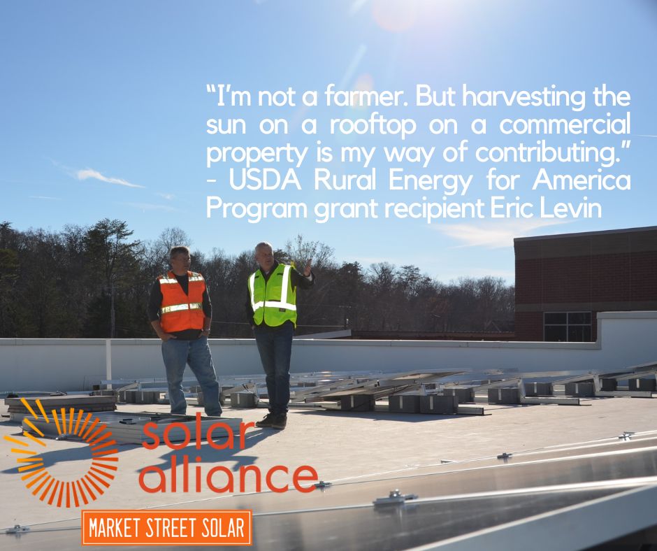 Rooftop solar array with two men standing