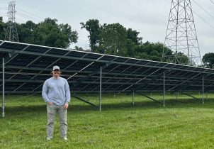 Man in front of large solar array