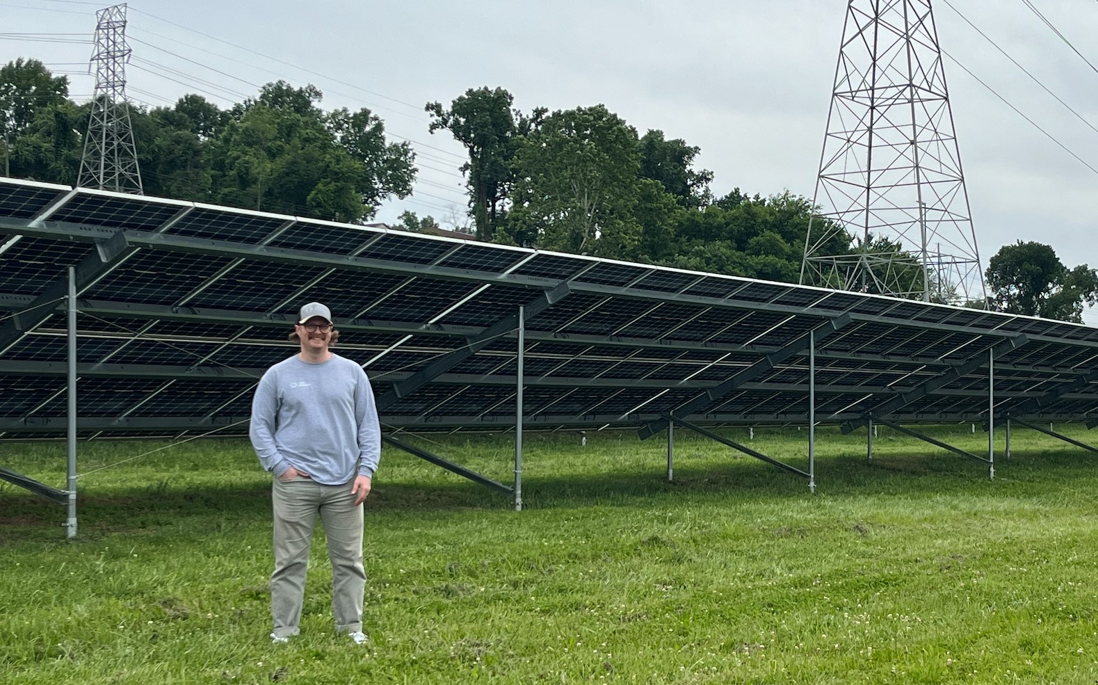 Man in front of large solar array