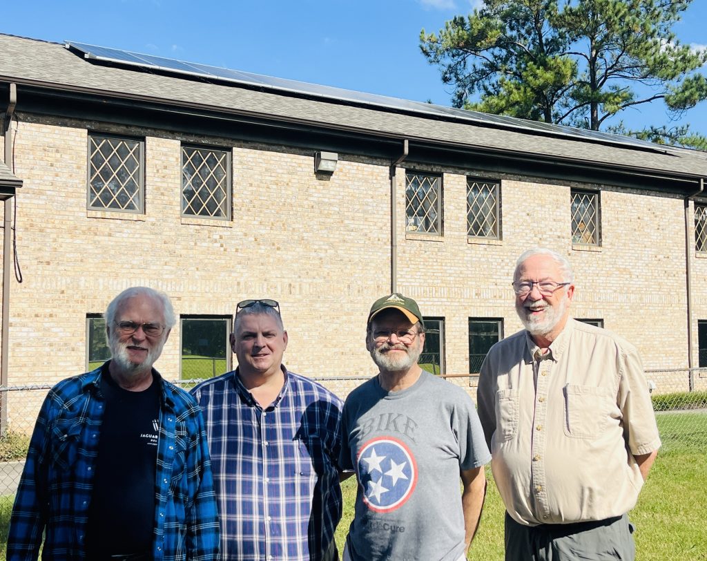 church members in front of building with new rooftop solar
