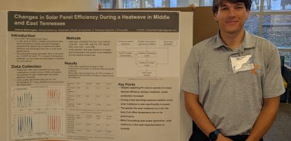 student with research poster on solar energy