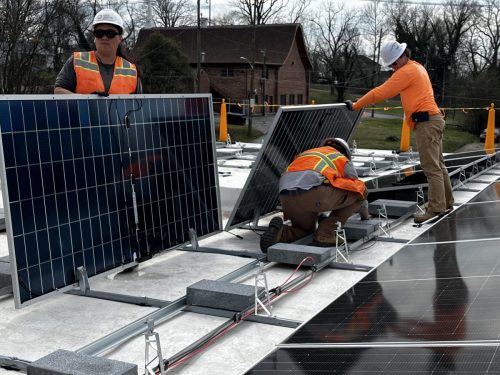 Construction Crew Installing Panels on Recreation Center Roof