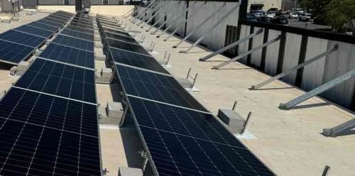 Ballasted array behind building facade